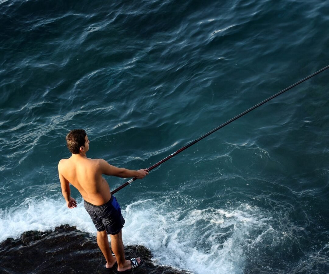 A fisherman on the rocks along the Beirut Corniche.