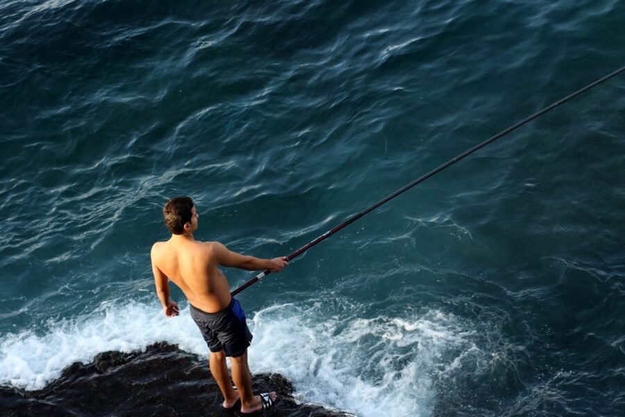 A fisherman on the rocks along the Beirut Corniche.